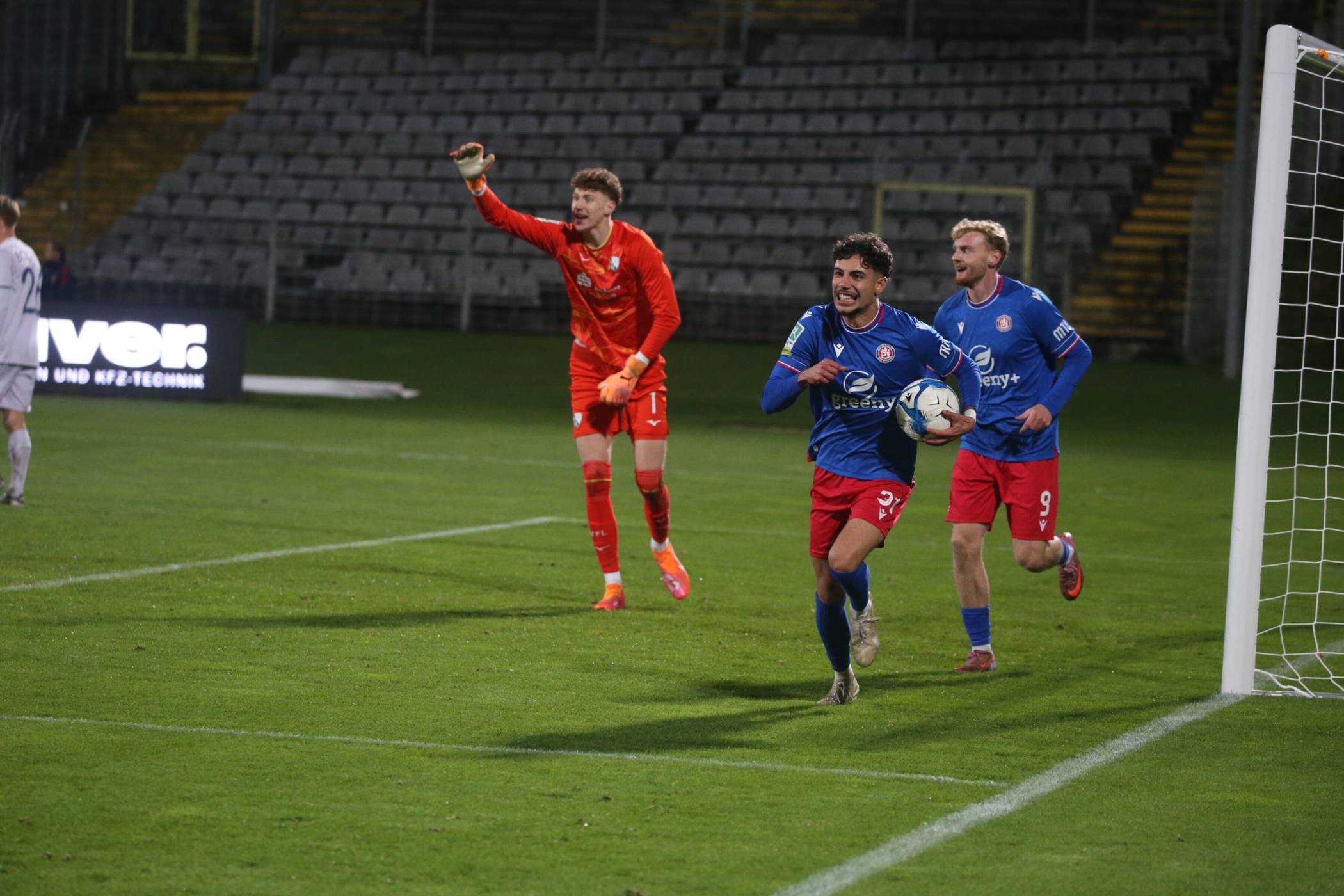  Ronay Arabacy trägt den Ball glücklich jubelnd nach seinem zwischenzeitlichen 1:1 aus dem Tor. Bochums Torhüter Hugo Röllecke reklamiert vergeblich Abseits.  