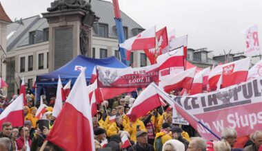 Demonstranten auf dem Schlossplatz in Warschau. Sie schwenken Fahnen.