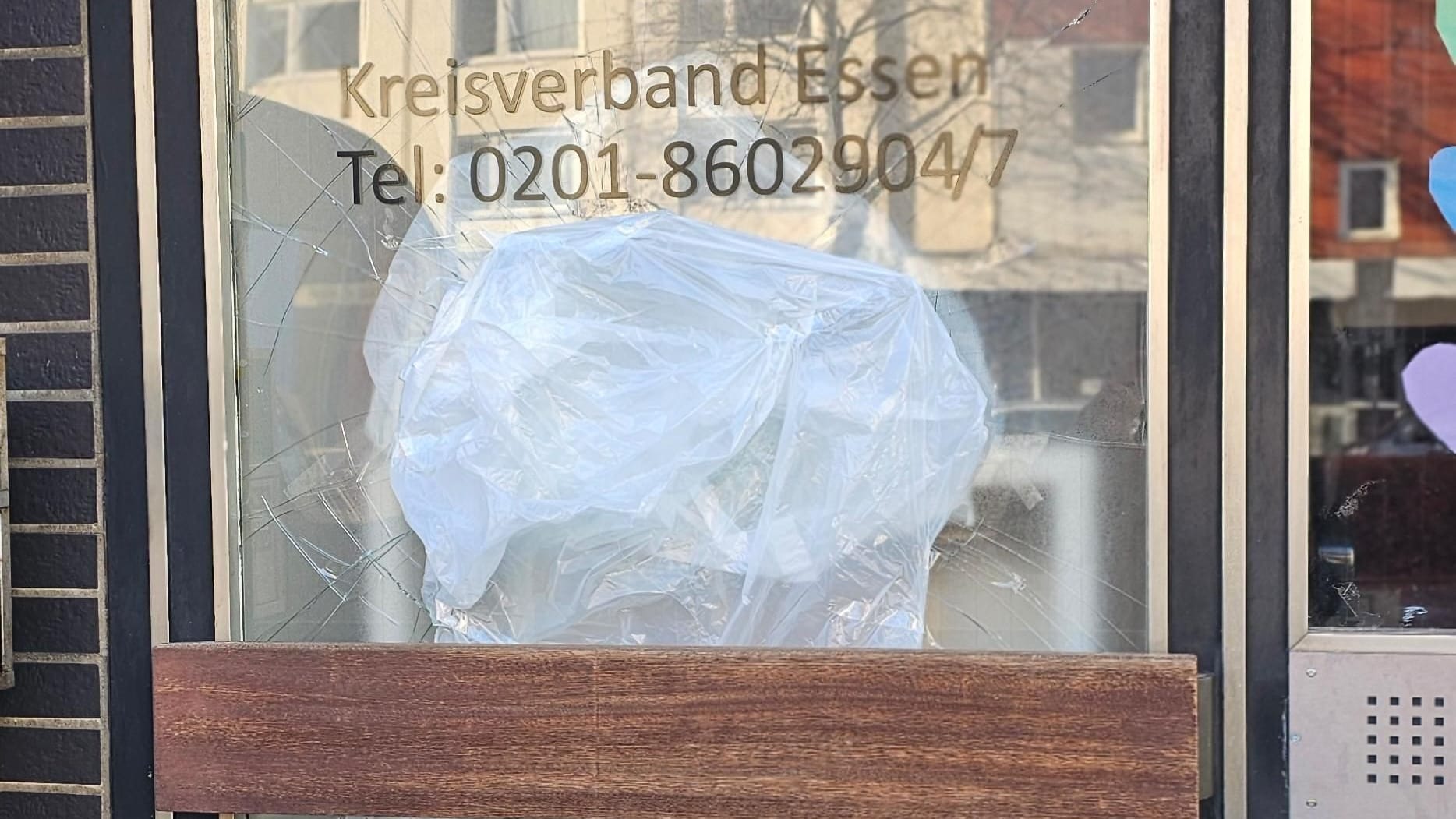 Unbekannte haben am Sonntag einen Backstein durch die Scheibe der Eingangstür des Essener Parteibüros der Linken geworfen: Das Foto zeigt den Schaden von außen.
