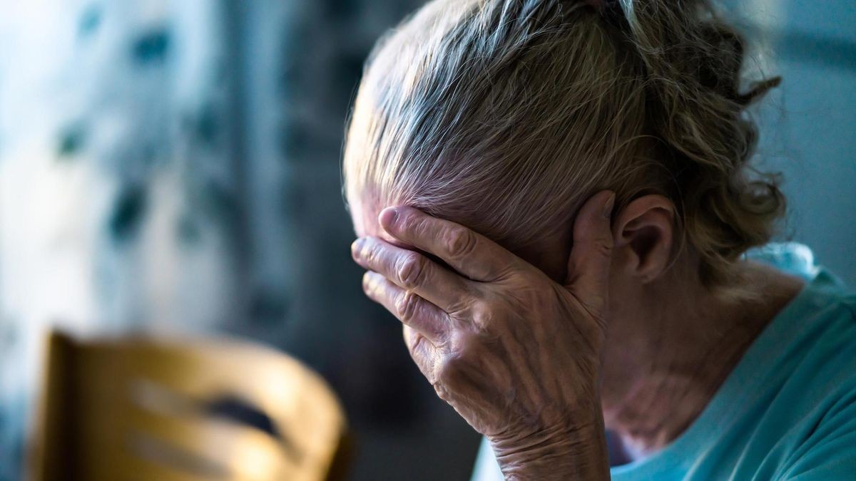 Sad senior old woman. Lonely from loss or sick with headache. Upset patient in retirement home with stress or pain. Alzheimer, depression, senility or dementia.