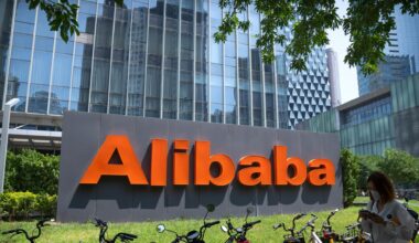 Der Schriftzug "Alibaba" steht vor einem gläseren Gebäude. Im Vordergrund stehen einige Fahrräder.