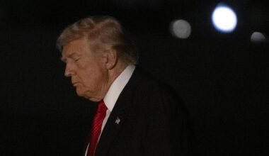 US-Präsident Trump im Anzug mit roter Krawatte in der Dunkelheit