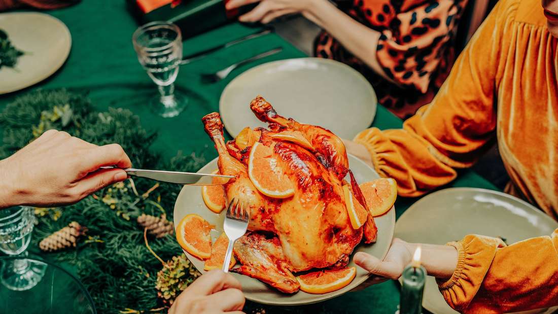Serving roast chicken at a vintage style Christmas dinner celebration Festliches Weihnachtsessen 