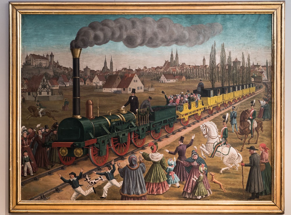 Die Fahrten der ersten Eisenbahn stoßen auf große Neugier: So etwas wie den  Adler  dürften die meisten Menschen in Nürnberg und Fürth noch nie zuvor in ihrem Leben gesehen haben. Dieser Eindruck lässt sich auch von diesem historischen Gemälde ableiten.