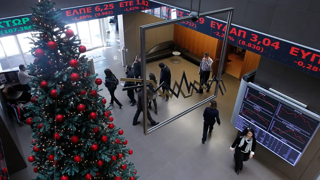 People-view-the-screens-showing-financial-stocks-behind-a-Christmas-tree-at-the-Athens-Stock-Exchange-Friday-Dec-9-2011-European-leaders-are-examining-tougher-budget-enforcement-rules-to-try-to-stem-a-eurozone-debt-crisis-that-is-threatening-the-euro-The-values-of-shares-on-the-Greek-bourse-has-fallen-sharply-throughout-the-year-amid-a-deepening-recession