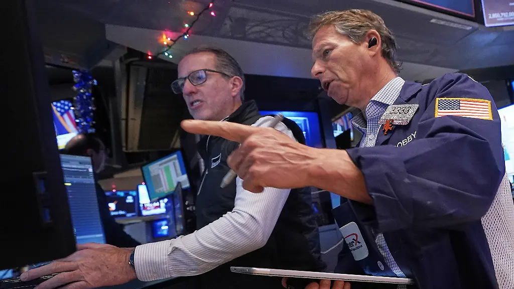 Specialist-Glenn-Carell-left-and-trader-Robert-Charmak-work-on-the-floor-of-the-New-York-Stock-Exchange-Thursday-Dec-11-2025