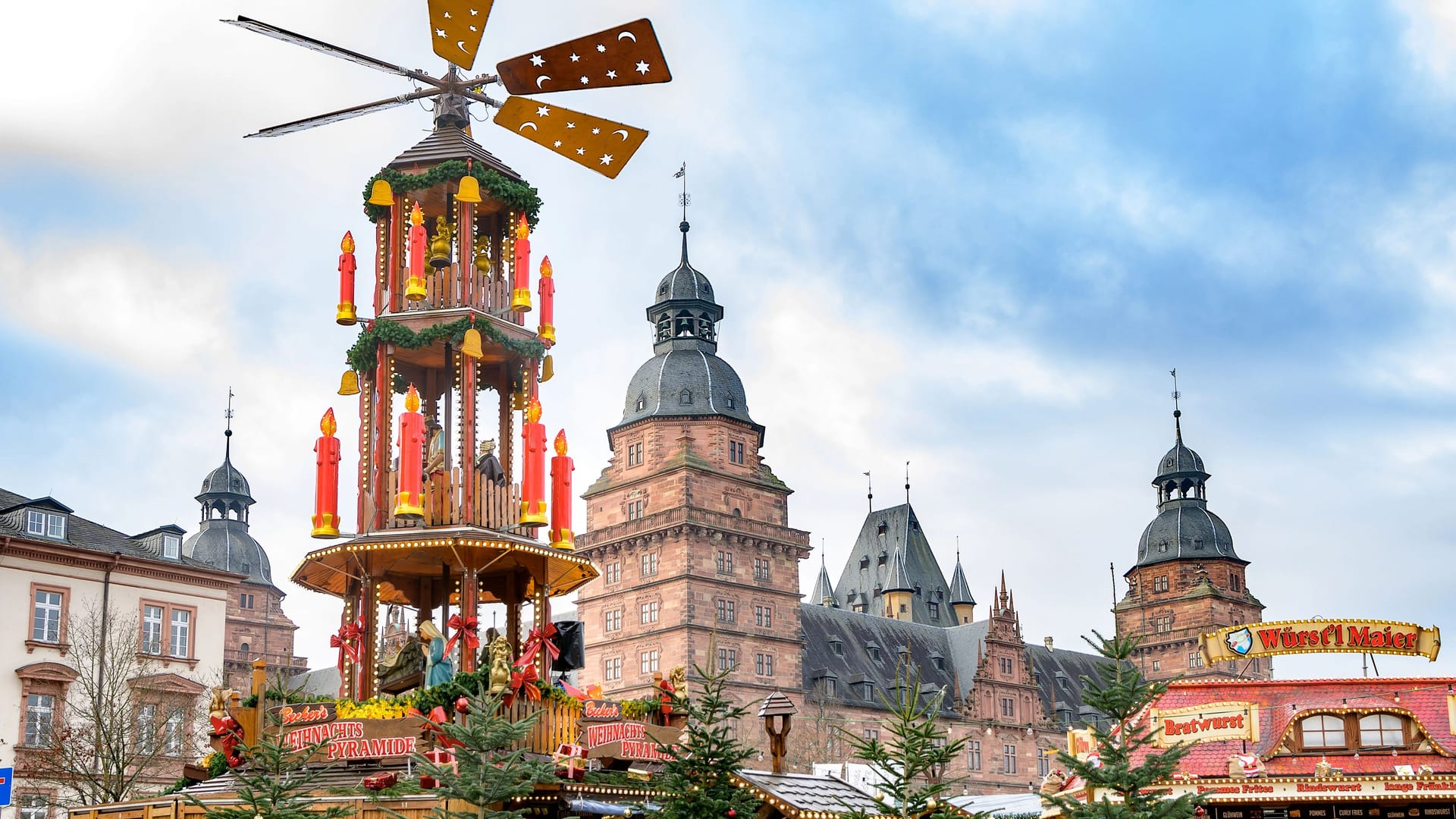Aschaffenburg, Germany - November 30, 2019: Christmas pyramid on the advent market at the famous Castle Johannisburg in Aschaffenburg Aschaffenburg, Germany - November 30, 2019: Christmas pyramid on the advent market at the famous Castle Johannisburg in Aschaffenburg