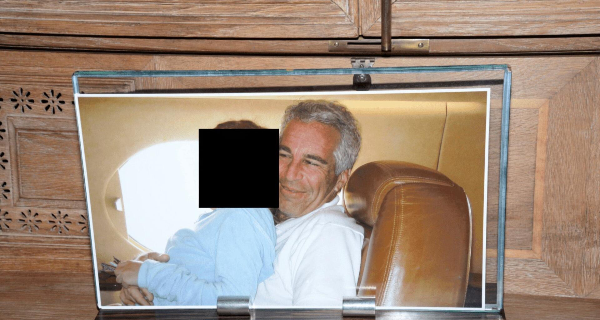 Jeffrey Epstein mit einer unkenntlichen Person auf dem Schoß