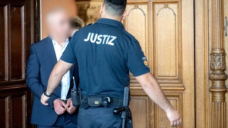 Der Angeklagte (l) wird in Handschellen vor Prozessbeginn in den Gerichtssaal geführt: Der Mann wurde jetzt zu einer Haftstrafe verurteilt.