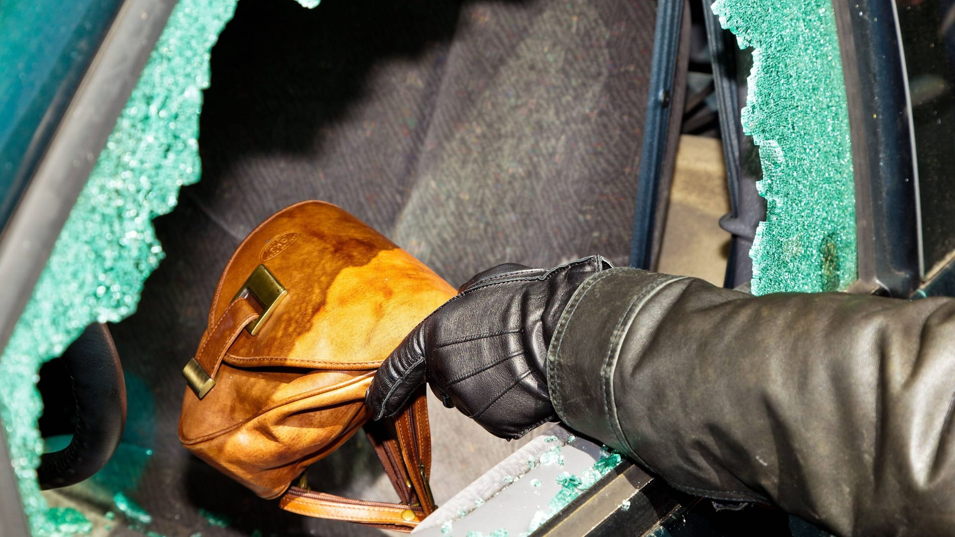 Dieb stiehlt eine Handtasche aus dem Auto (Archivbild): In Dresden wurde in vielen Fahrzeugen eingebrochen. Dieb stiehlt eine Handtasche aus dem Auto (Archivbild): In Dresden wurde in vielen Fahrzeugen eingebrochen.