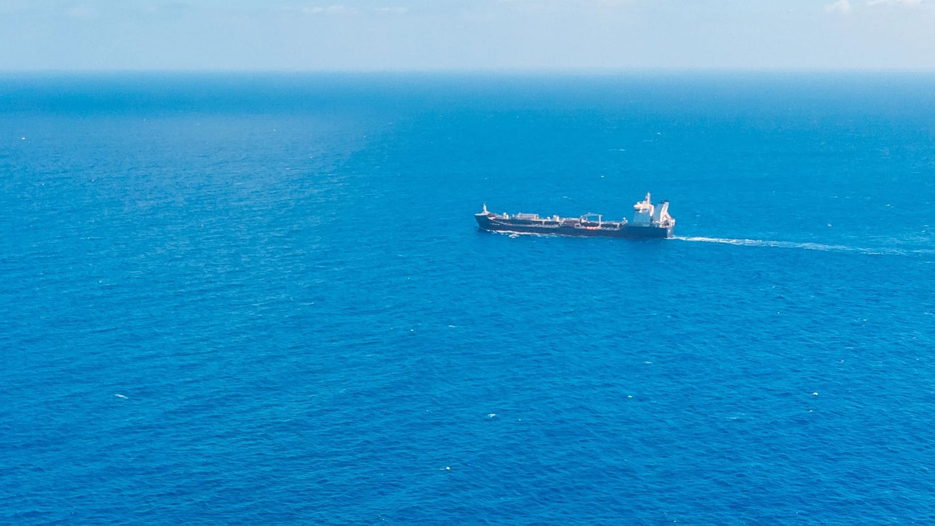 Oil ship chemical tanker sails blue sea. Aerial top view. Concept export