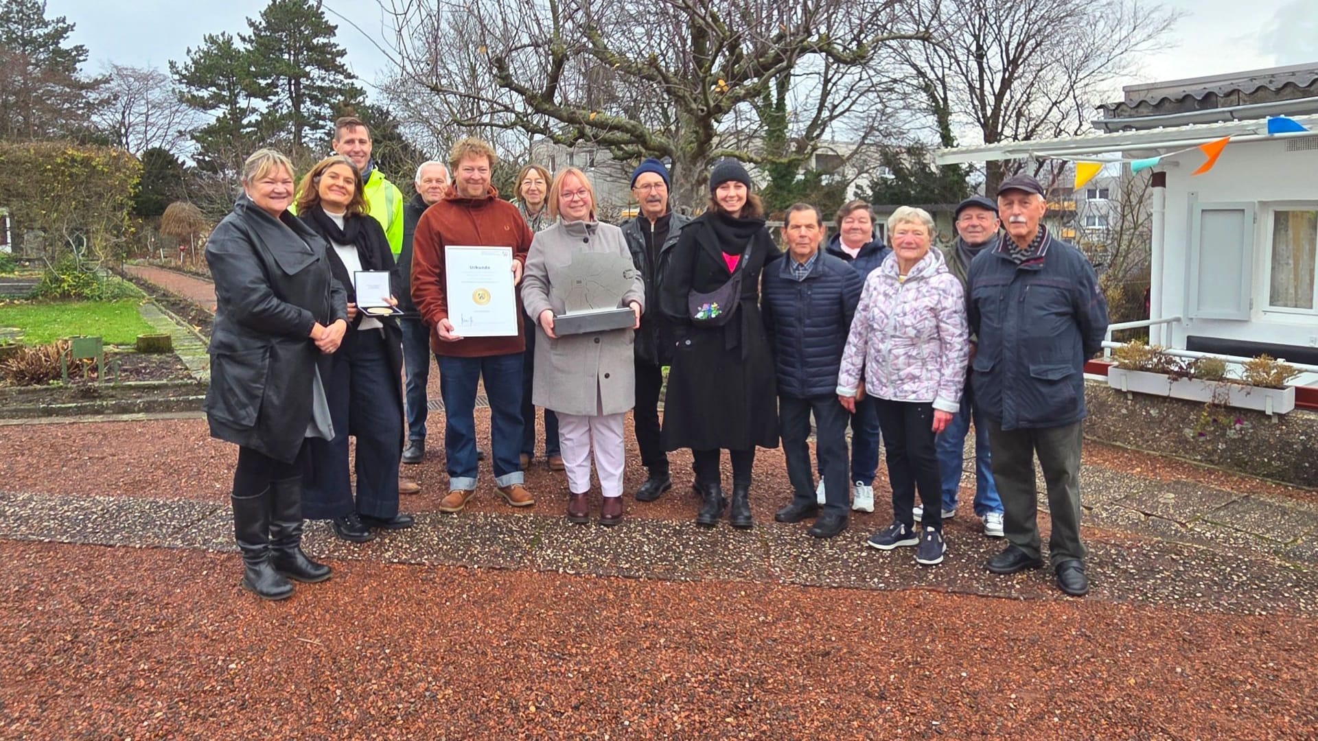 Stolz auf die Goldmedaille beim NRW-Wettbewerb: Die Beteiligten an der Kleingartenanlage in der Soldatengasse.
