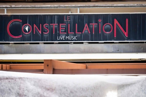 This photograph shows the sign indicating the bar Le Constellation displayed on its facade, where a fire ripped through the venue during New Year's Eve celebrations in the Alpine ski resort town of Crans-Montana killing around 40 people and injuring more than 100 others, in Crans-Montana on January 2, 2026. Investigators raced on January 2, 2026 to identify the victims of a fire that ripped through a bar in the Swiss Alps town of Crans-Montana, turning a New Year's celebration into one of the country's worst tragedies. Frederic Gisler, police commander in the Wallis canton in southwestern Switzerland, told reporters that authorities had counted "around 40 people who have died and around 115 injured, most of them seriously". (Photo by MAXIME SCHMID / AFP)
