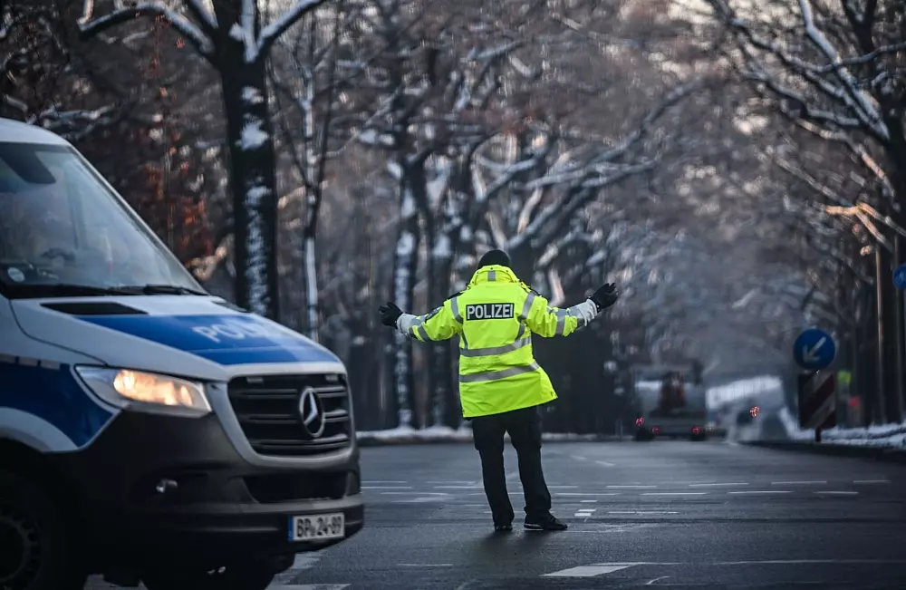 Ein Polizist regelt den Verkehr an einer Kreuzung, an der die Ampel ausgefallen ist. - © Britta Pedersen/dpa