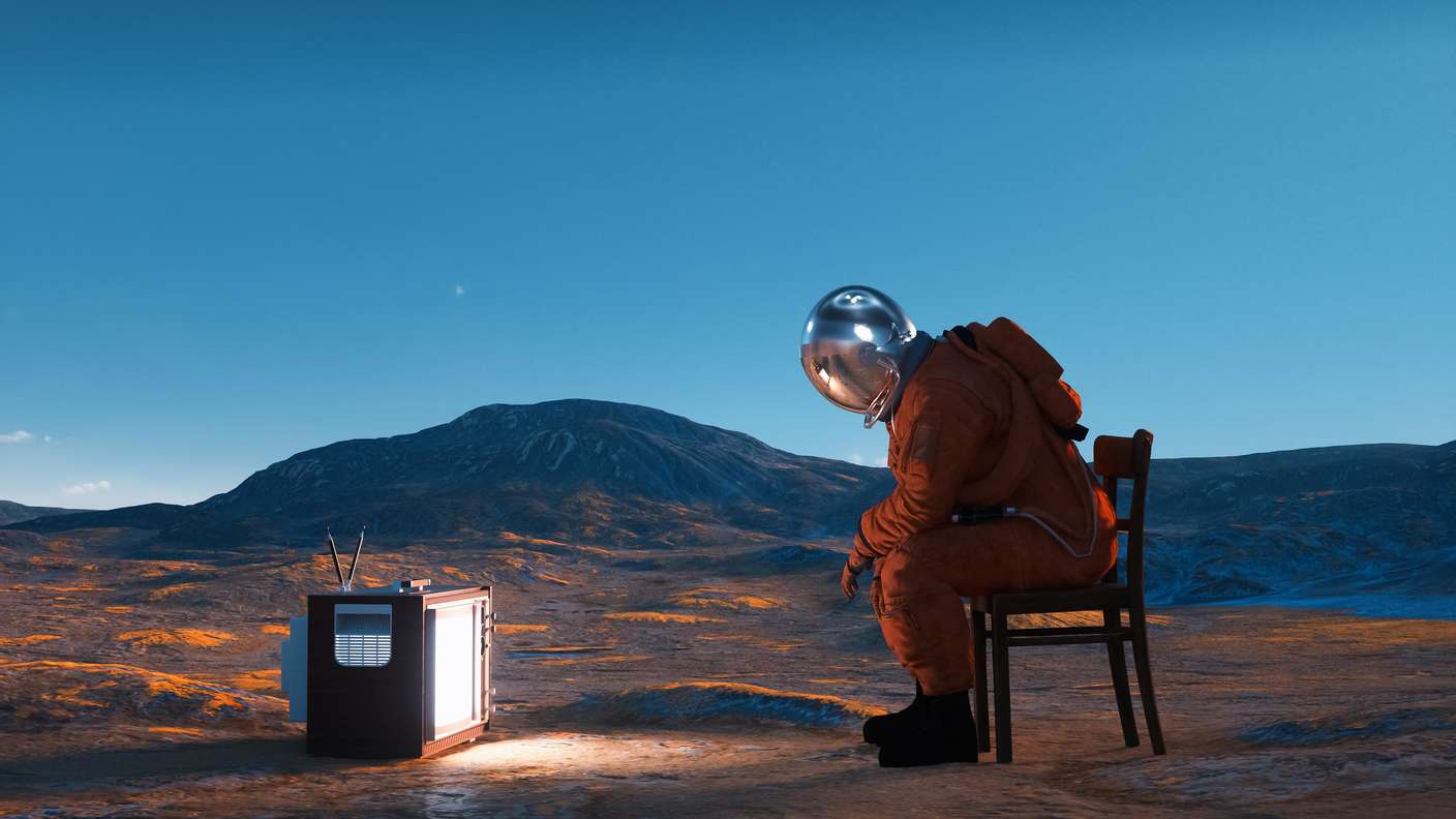 Astronaut watching tv on the moon. Digital media and streaming concept.