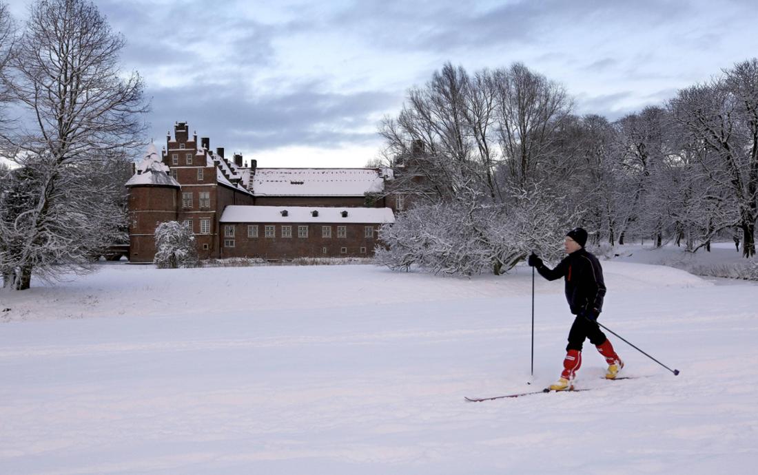 Skiläufer am Wasserschloss Herten im Schnee, NRW, Deutschland