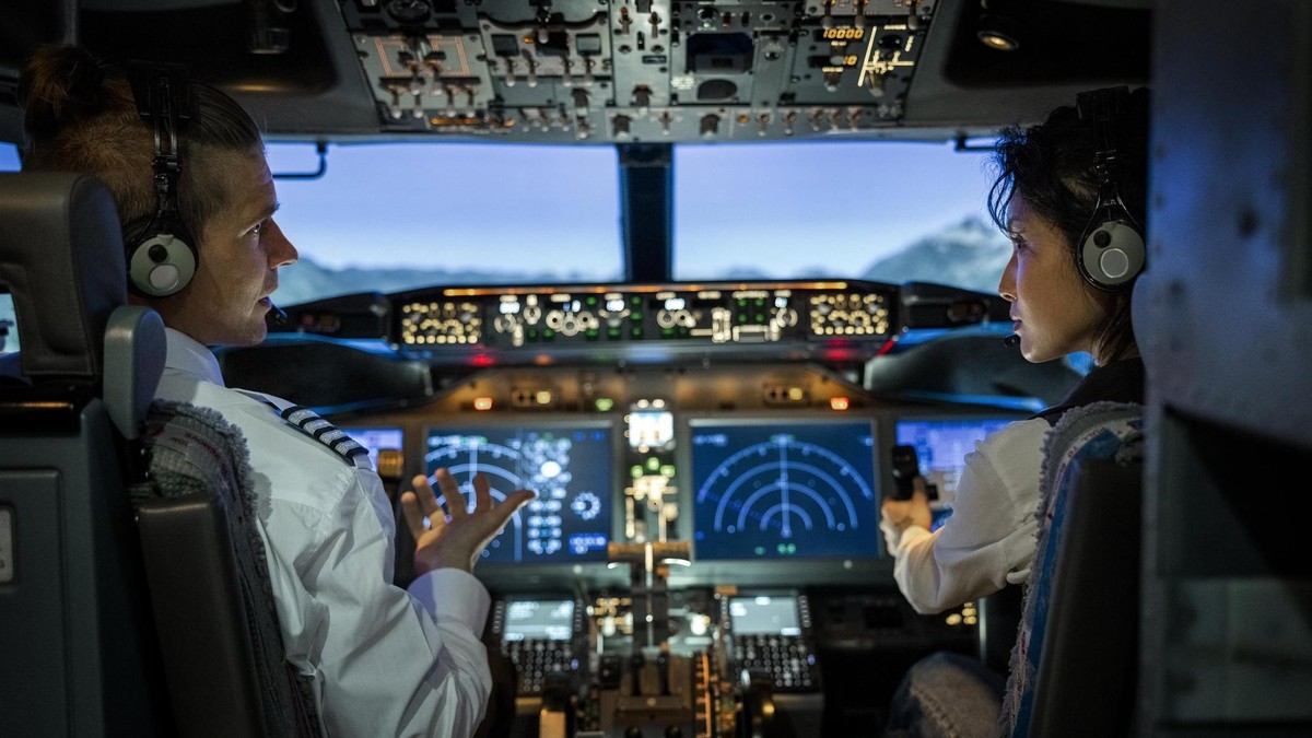 Rear view of two pilots flying an commercial airplane jet