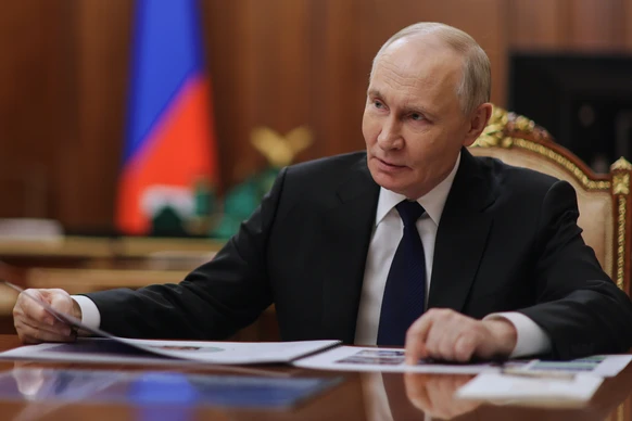 Russian President Vladimir Putin listens to Russian Deputy Defense Minister and chairwoman of the Defenders of the Fatherland Foundation Anna Tsivileva during their meeting at the Kremlin in Moscow, R ...