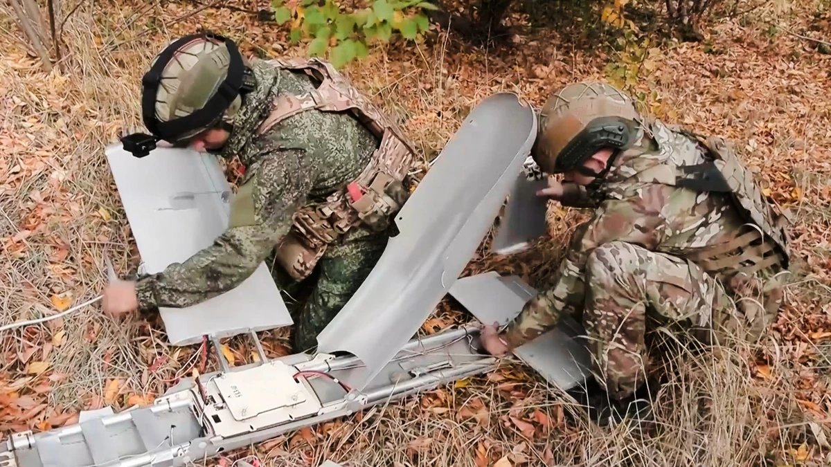 In this image made from video provided by Russian Defense Ministry Press Service on Thursday, Oct. 30, 2025, Russian soldiers prepare a strike FPV drone aircraft "Molniya-2" to fly towards U ...