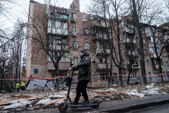 A man rides by electric scooter in front of the apartment building damaged after a Russian strike on Kyiv, Ukraine, on Saturday, Dec. 27, 2025. (AP Photo/Evgeniy Maloletka)
Russia Ukraine War