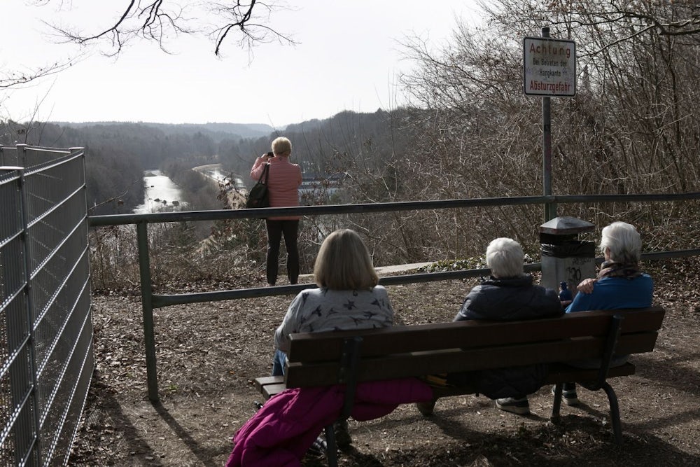 Begehrte Sitzbank mit Blick aufs Isartal: Wer die Wintersonne noch aktiver genießen will, kann auf dem Damm unten zwischen Fluss und Kanal spazieren.