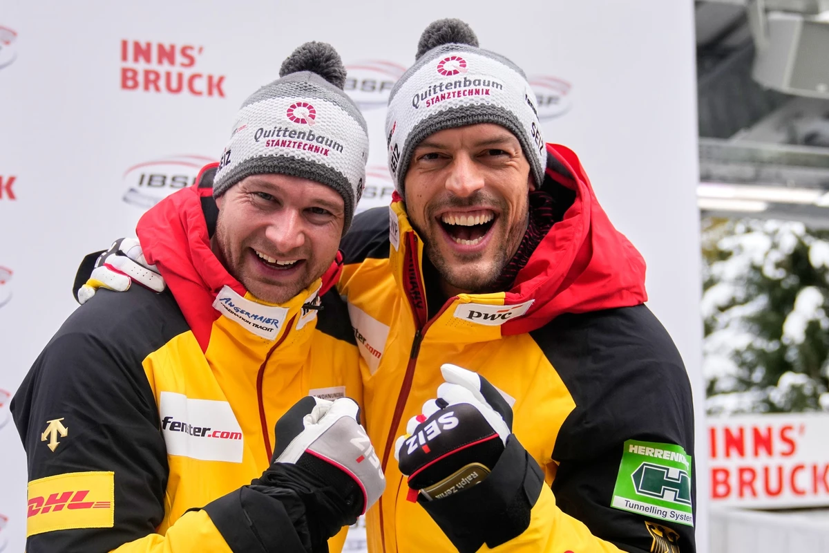 Johannes Lochner and Georg Fleischhauer of Germany celebrate winning the 2-man bobsleigh, at the Bobsleigh World Cup in Innsbruck, Austria, Saturday, Nov. 29, 2025. (AP Photo/Matthias Schrader)