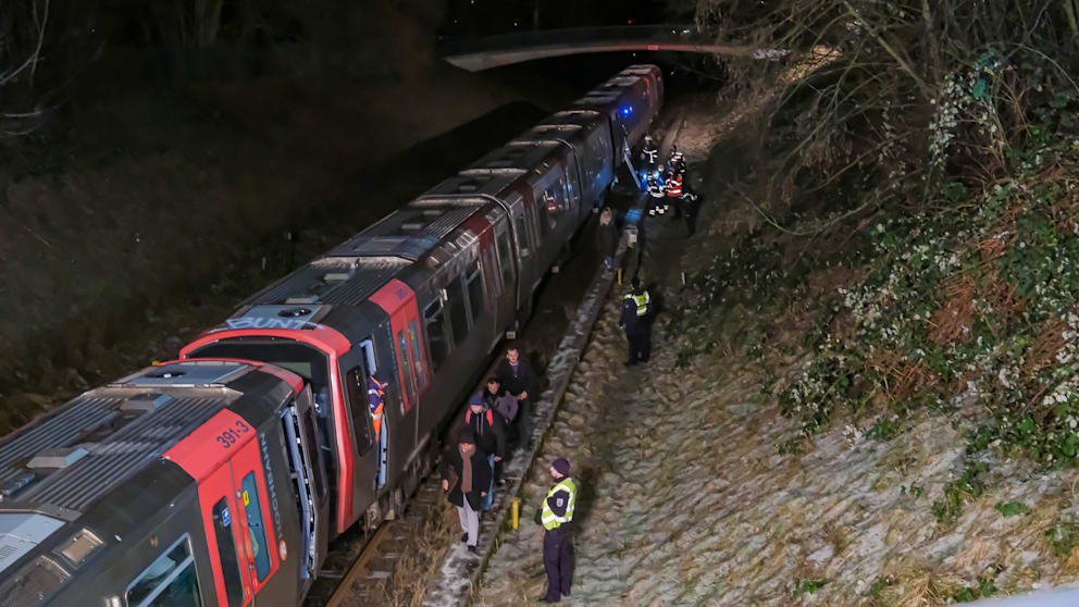 Feuerwehr und Sicherheitskräfte geleiten die Passagiere aus dem Zug