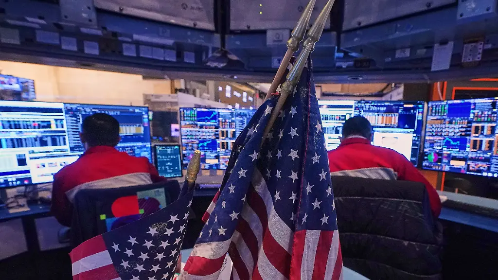 A-pair-of-traders-work-on-the-floor-of-the-New-York-Stock-Exchange-Monday-Jan-12-2026