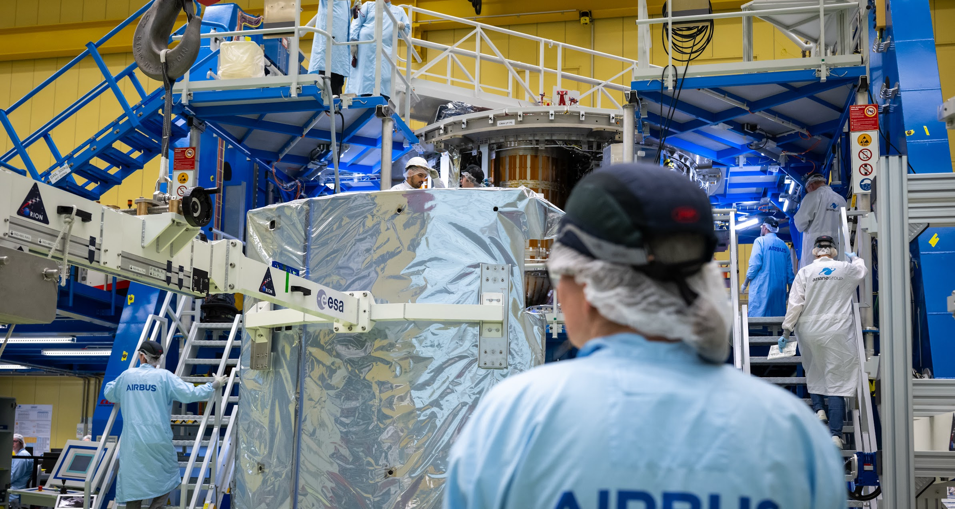 Engineers at Airbus in Bremen install one of the shield panels on ESA