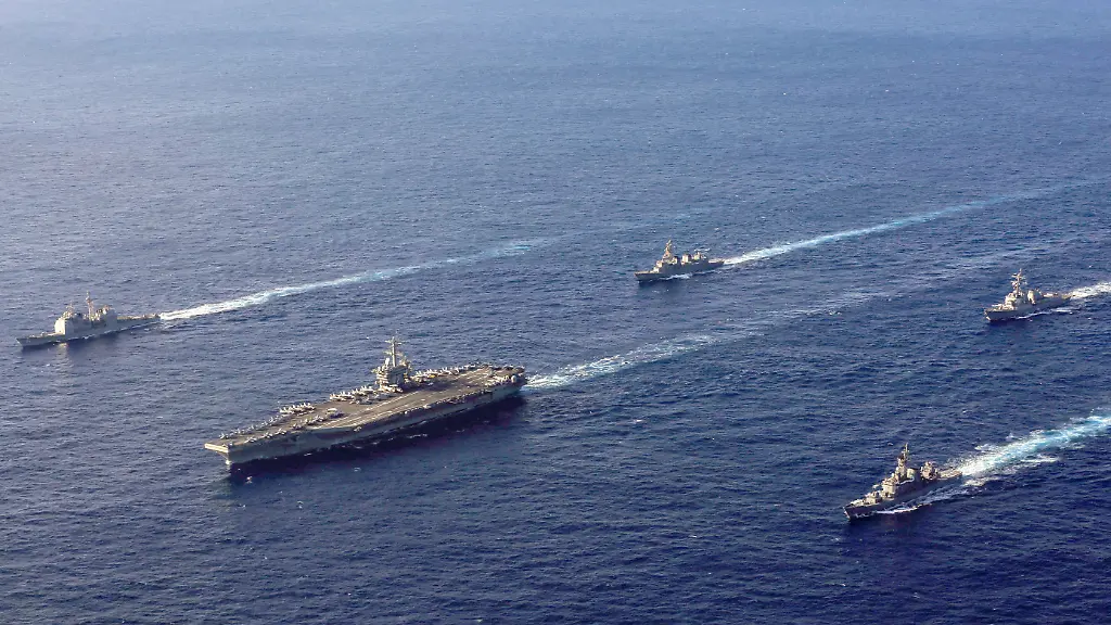 Handout-photo-dated-February-16-2022-of-the-Nimitz-class-aircraft-carrier-USS-Abraham-Lincoln-CVN-72-the-Ticonderoga-class-guided-missile-cruiser-USS-Mobile-Bay-CG-53-and-the-Arleigh-Burke-class-guided-missile-destroyer-USS-Spruance-DDG-111-are-underway-in-formation-with-the-Japan-Maritime-Self-Defense-Force-JMSDF-Murasame-class-destroyer-JS-Inazuma-DD-105-and-the-training-vessel-Hatakaze-class-JS-Hatakaze-TV-3520-during-exercise-Jungle-Warfare-2022-JWX-22-in-the-Philippine-Sea-The-US-is-sending-a-carrier-strike-group-a-fighter-squadron-and-additional-warships-to-the-Middle-East-as-the-region-braces-for-an-Iranian-retaliation-to-the-killing-of-a-senior-Hamas-leader-in-Tehran-earlier-this-week-On-Friday-August-2-2024-Defense-Secretary-Lloyd-Austin-ordered-the-USS-Abraham-Lincoln-strike-group-to-replace-the-USS-Theodore-Roosevelt-strike-group-which-is-currently-operating-in-the-Gulf-of-Oman-according-to-a-statement-from-Pentagon-deputy-press-secretary-Sabrina-Singh-U-S-Navy-photo-by-Mass-Communication-Specialist-3rd-Class-Lake-Fultz-via-ABACAPRESS