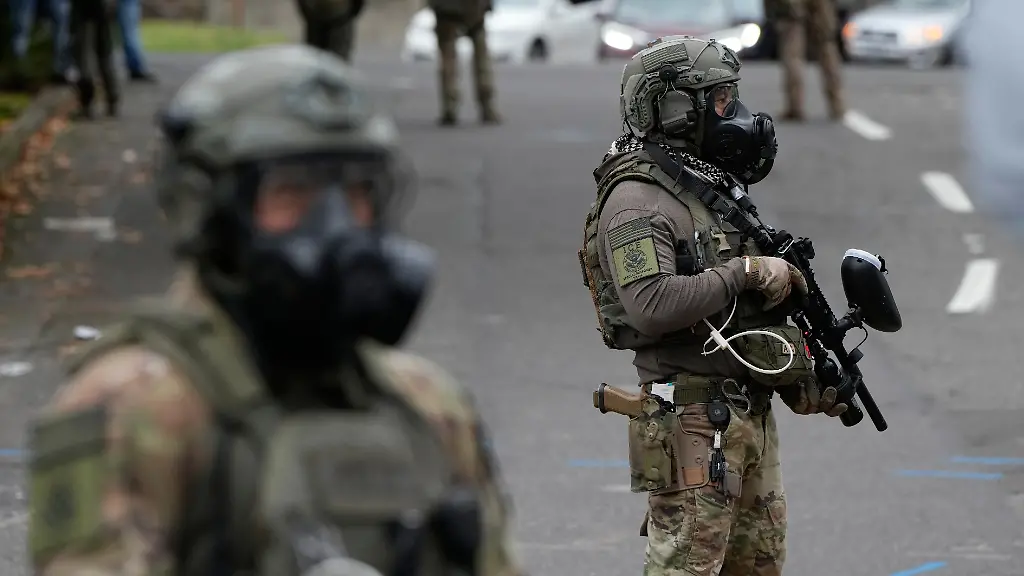 Immigration-and-Customs-Enforcement-agents-stand-outside-an-ICE-facility-during-a-protest-on-Saturday-Oct-4-2025-in-Portland-Ore