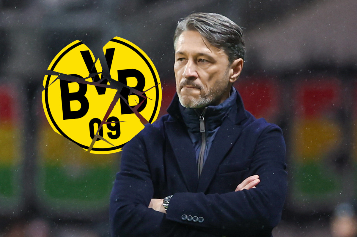 Niko Kovac schaut frustriet und mit verschränkten Armen auf ein BVB-Logo.