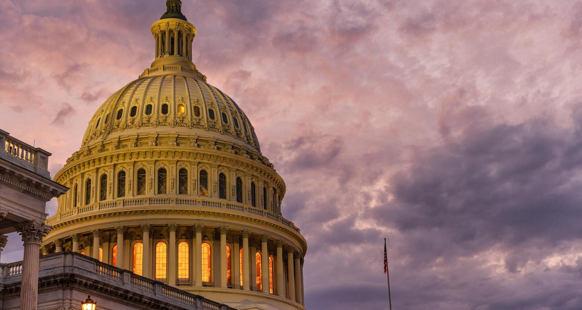 Violet sunset sky over the US Capitol building dome