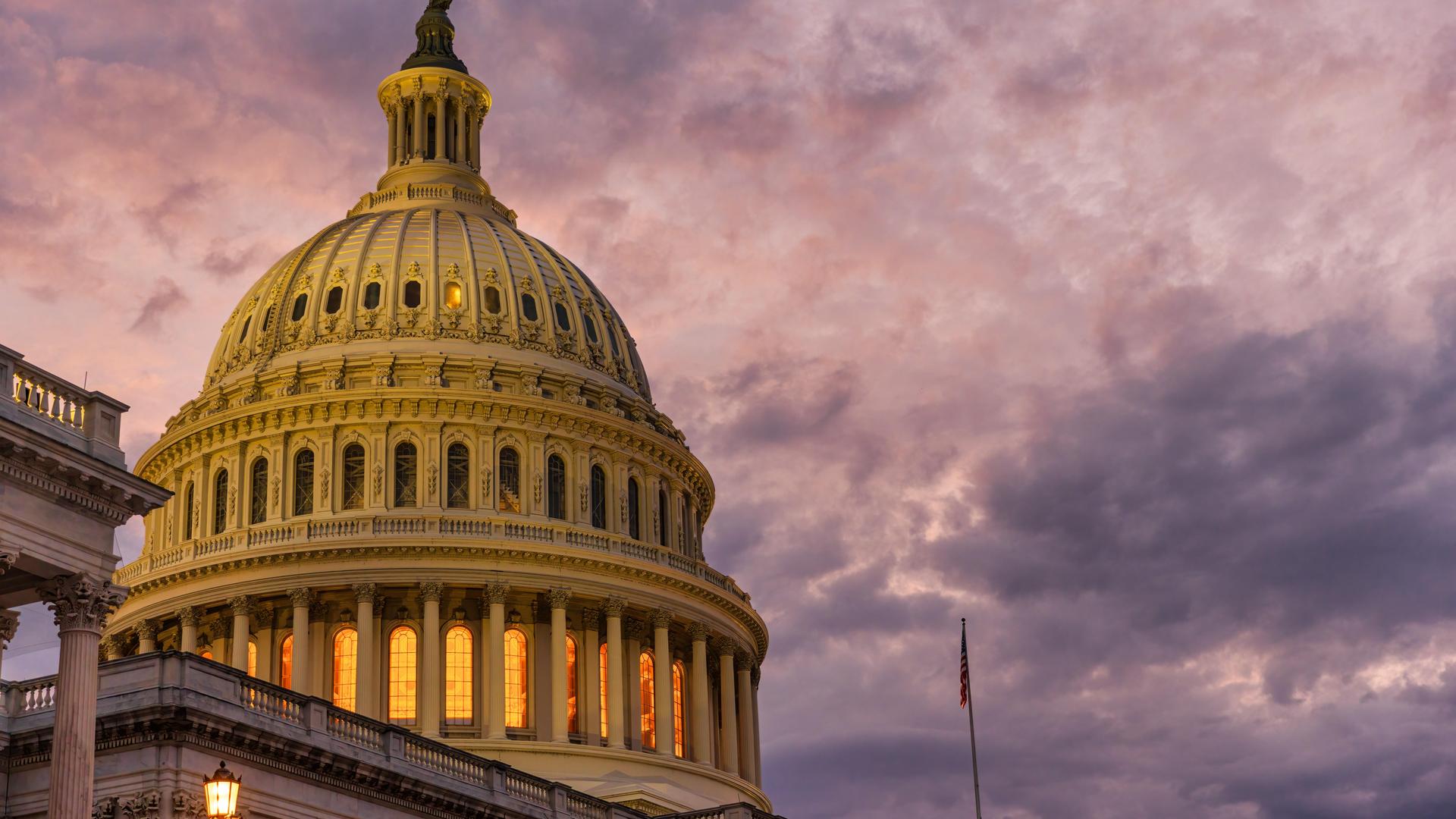 Violet sunset sky over the US Capitol building dome