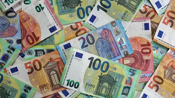 Verschiedene Euro-Banknoten liegen auf einem Tisch. 
