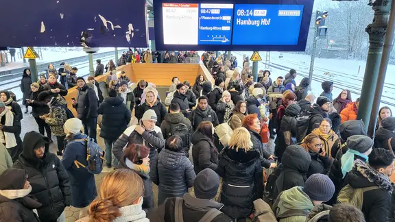 Viele Menschen stehen an dem Bahnhof in Hamburg-Harburg.