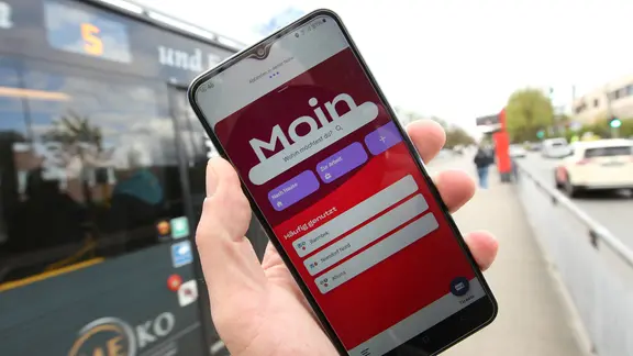 Auf einem Smartphone ist die App vom Hamburger Verkehrsverbund geöffnet. | IMAGO / Hanno Bode, Hanno Bode Auf einem Smartphone ist die App vom Hamburger Verkehrsverbund geöffnet.