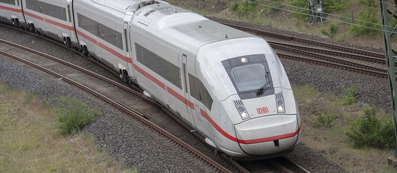 Ein ICE der Deutschen Bahn fährt durch eine Landschaft.