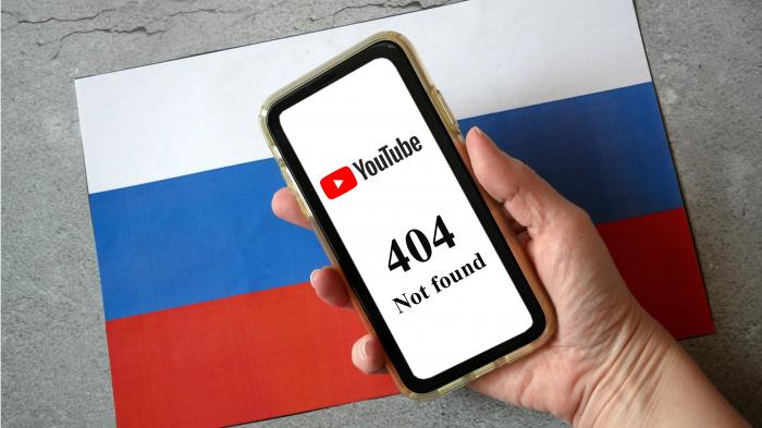 Moskau, Russland - 6. August 2024: Hand, die ein Mobiltelefon mit YouTube-Zeichen und 404 Fehler hält Seite nicht auf dem Bildschirm auf russischem Hintergrund gefunden. Nahaufnahme