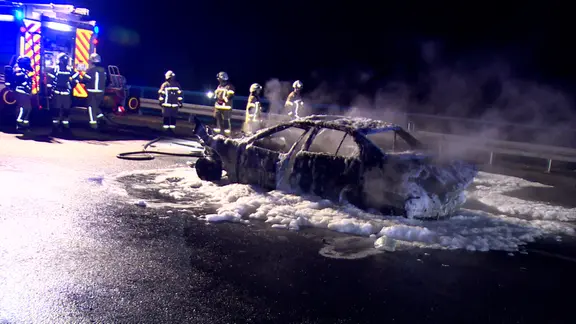 Ein Auto steht ausgebrannt auf der A2 nach einem Unfall. 