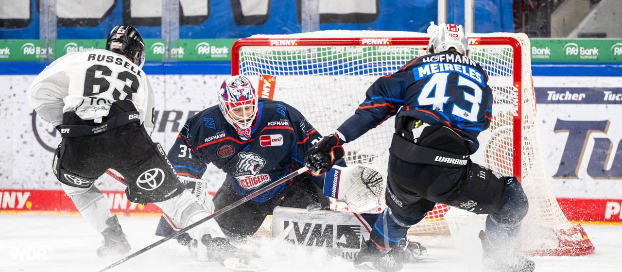 DEL-Profi Patrick Russell (l.) von den Kölner Haien schießt beim Spiel in Nürnberg auf das Tor | imago/Zink/Hahn DEL-Profi Patrick Russell (l.) von den Kölner Haien schießt beim Spiel in Nürnberg auf das Tor