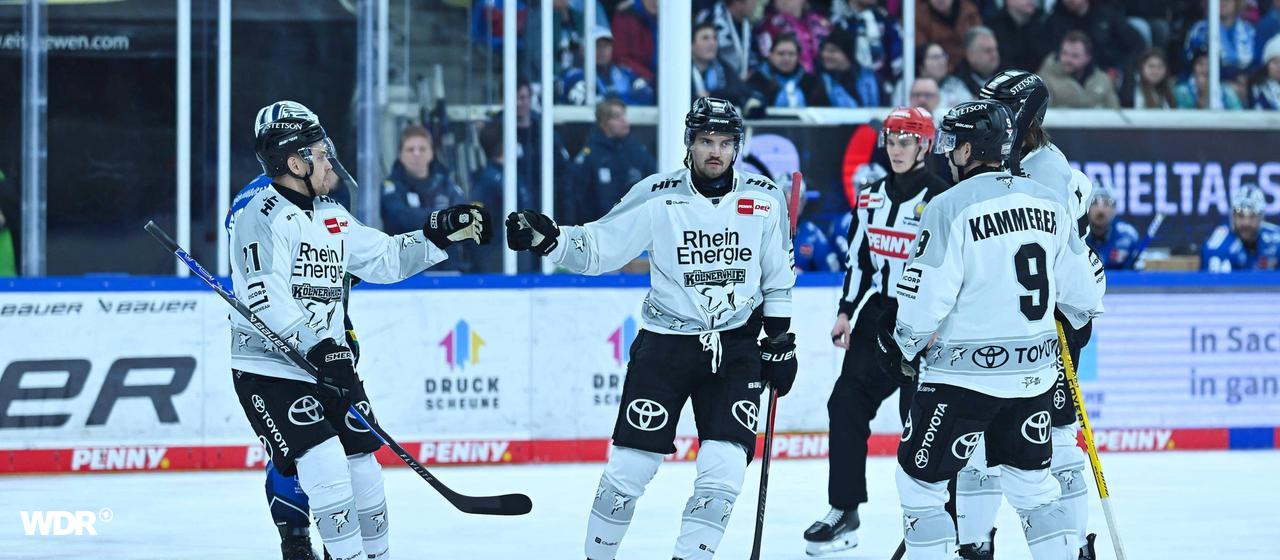 Die Spieler der Kölner Haie jubeln über ein Tor bei den Dresdner Eislöwen.