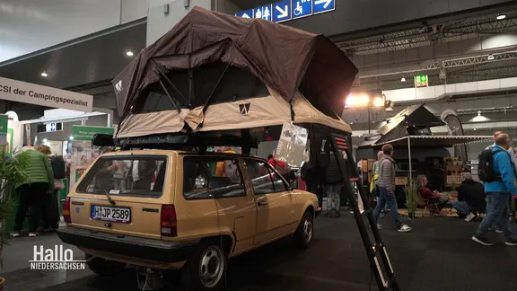 Ein Dachzelt wird auf einer Messe ausgestellt. | Screenshot Ein Dachzelt wird auf einer Messe ausgestellt.