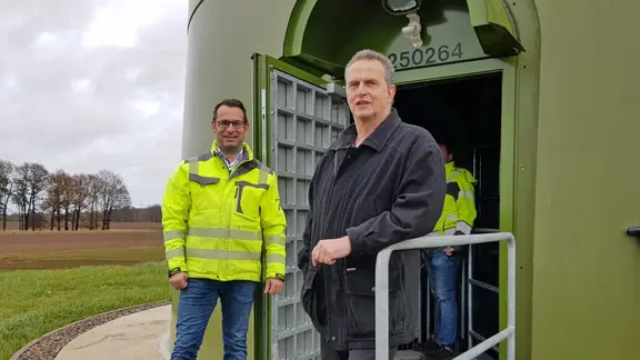 Steyerbergs Bürgermeister Jürgen Weber (rechts) steht vor dem Eingang eines Windrades. | NDR, Verena Ondorza Steyerbergs Bürgermeister Jürgen Weber (rechts) steht vor dem Eingang eines Windrades.