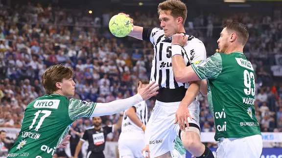 Zweikampf zwischen Nils Lichtlein (Füchse Berlin), Nikola Bilyk (THW Kiel) und Mijajlo Marsenic (Füchse Berlin)