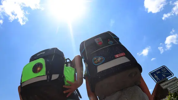 Zwei Schüler mit Schulranzen. Darüber die Sonne. | picture alliance/dpa | Karl-Josef Hildenbrand Zwei Schüler mit Schulranzen. Darüber die Sonne.