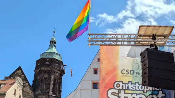 Regenbogenfahnen an einer Bühne und an einem Kirchturm | MDR/Philipp Brendel Regenbogenfahnen an einer Bühne und an einem Kirchturm