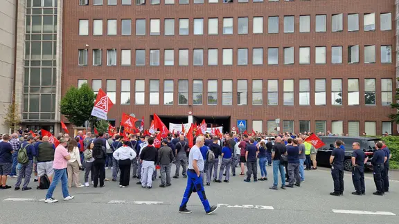Dutzende Menschen stehen in Hannover-Stöcken vor dem VW-Werk. | NDR, Maren Bruns Mitarbeitende von Volkswagen beteiligen sich an einer Informations- und Protestaktion der IG Metall vor dem VW-Werk in Hannover.