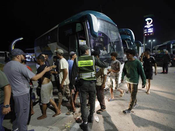 Migrants wait to board coaches as the Moroccan authorities transfer some back to their hometowns after they left Spain's North African enclave of Ceuta following an attempt to cross at the Morocco-Spain border, at Fnideq in northern Morocco on August 1, 2026. More than 48,000 migrants have returned to Morocco from Spain's Ceuta after tens of thousands crossed the frontier into its north African enclave in recent days, Spain's interior ministry said on July 31. Hundreds of people converged on Morocco's northern town of Fnideq on July 30 evening, following rumours that the border with Spain's Ceuta had opened, according to an AFP journalist. (Photo by Abdel Majid BZIOUAT / AFP)