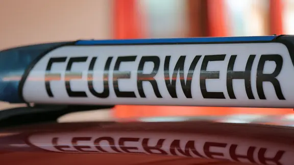 Schriftzug "Feuerwehr" steht auf einem Blaulicht eines Feuerwehrautos. | NDR, Pavel Stoyan Schriftzug "Feuerwehr" steht auf einem Blaulicht eines Feuerwehrautos.